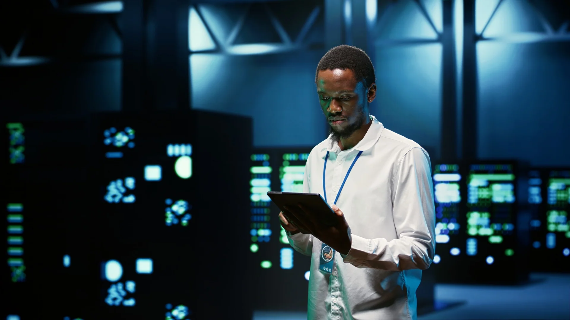Engineer checking server infrastructure on a tablet in a data center