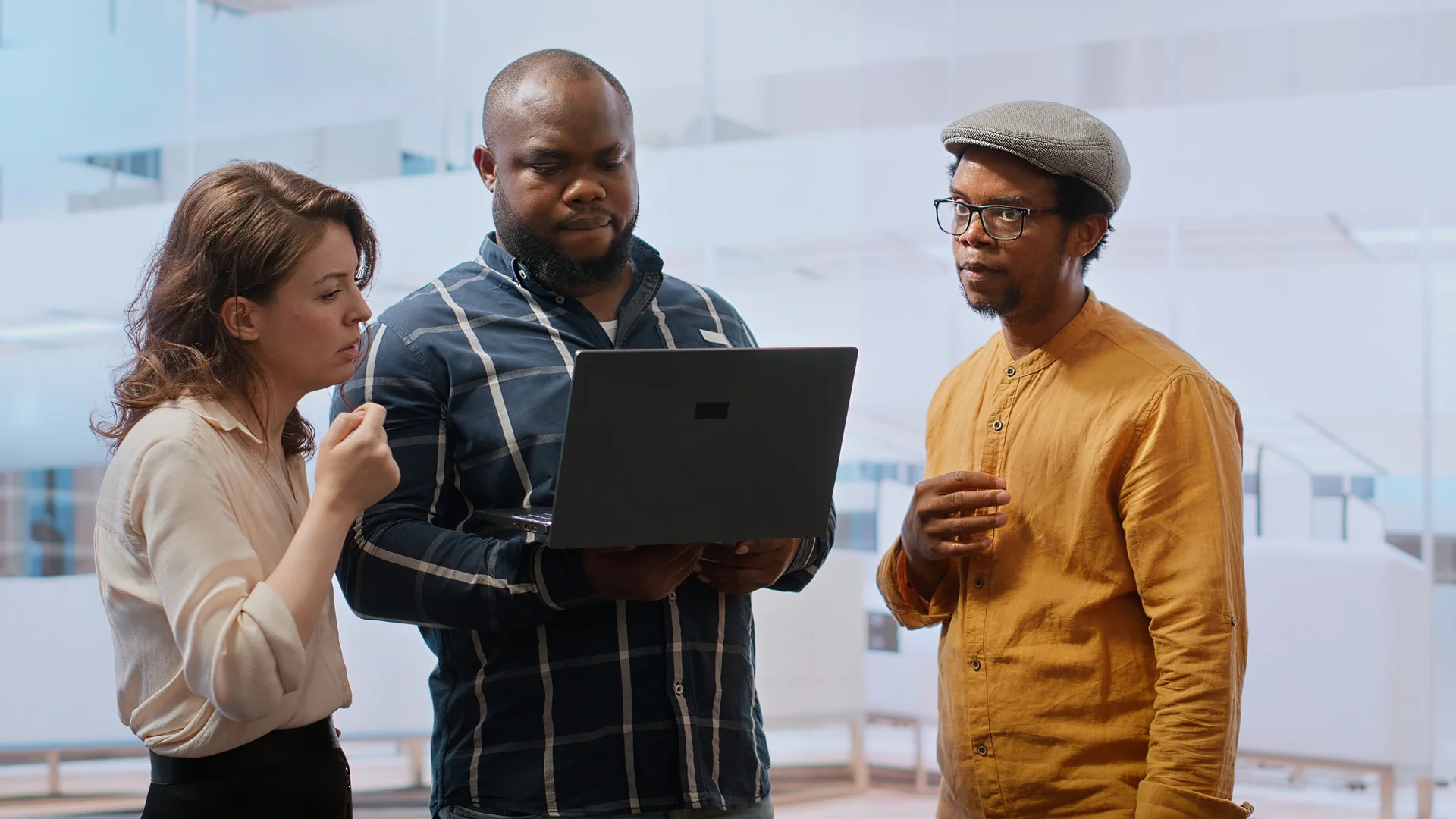 Team members reviewing a project together on a laptop